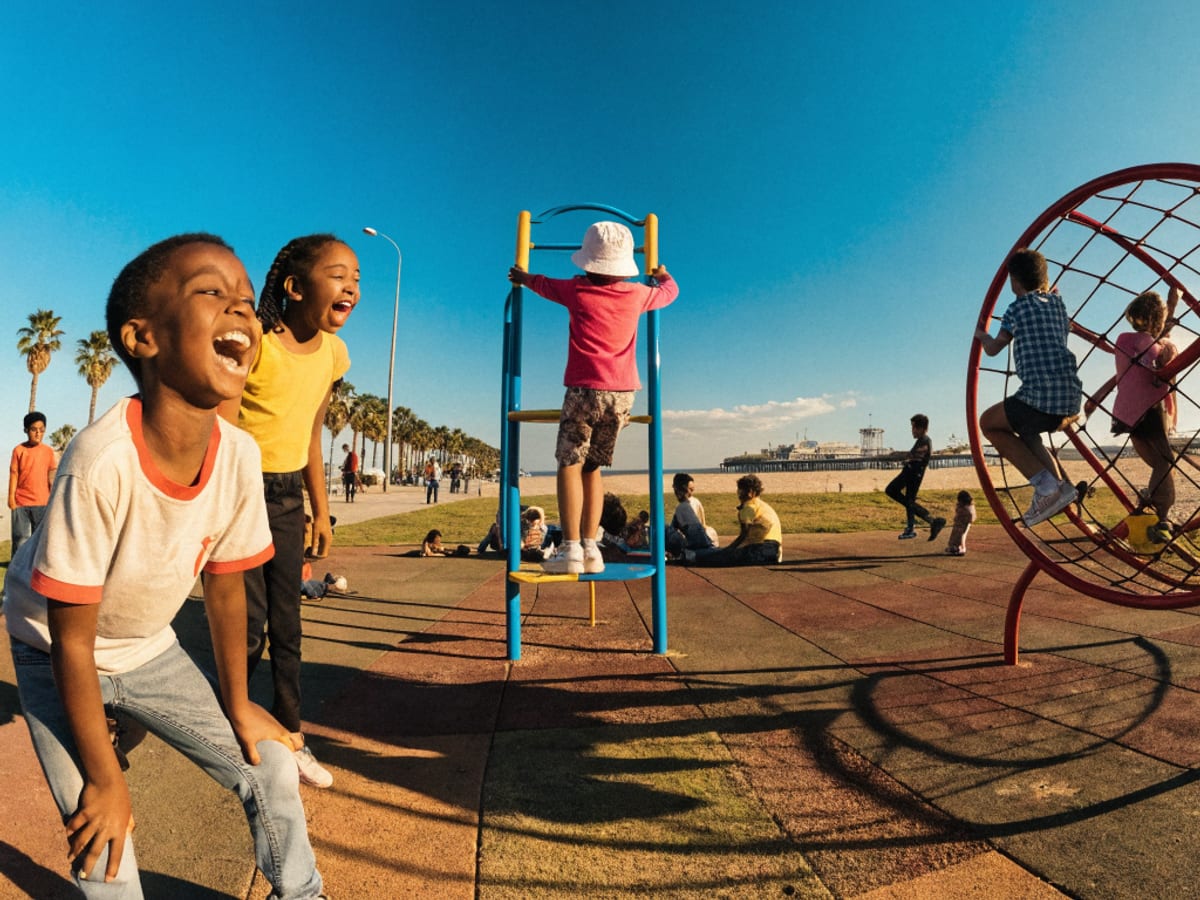 Children playing together on a playground climbing frame